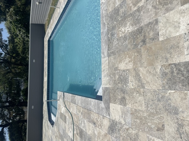 Pool and spa with travertine paver deck